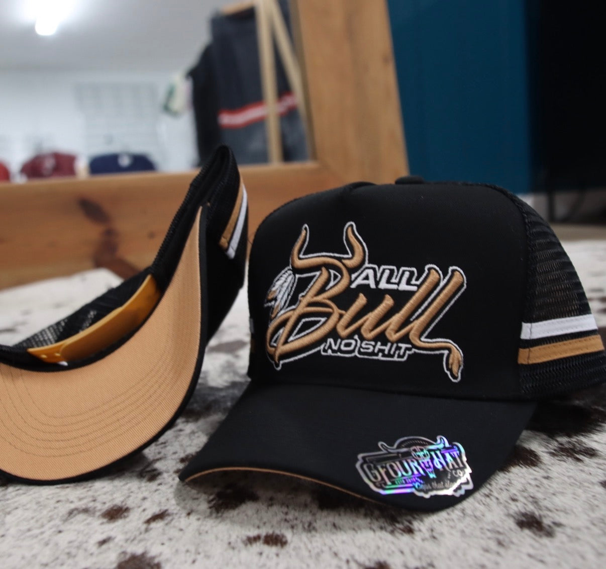 Black cap with 'All Bull No Shit' text and logo on a textured surface.